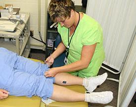 EKG Technician performing procedure on patient